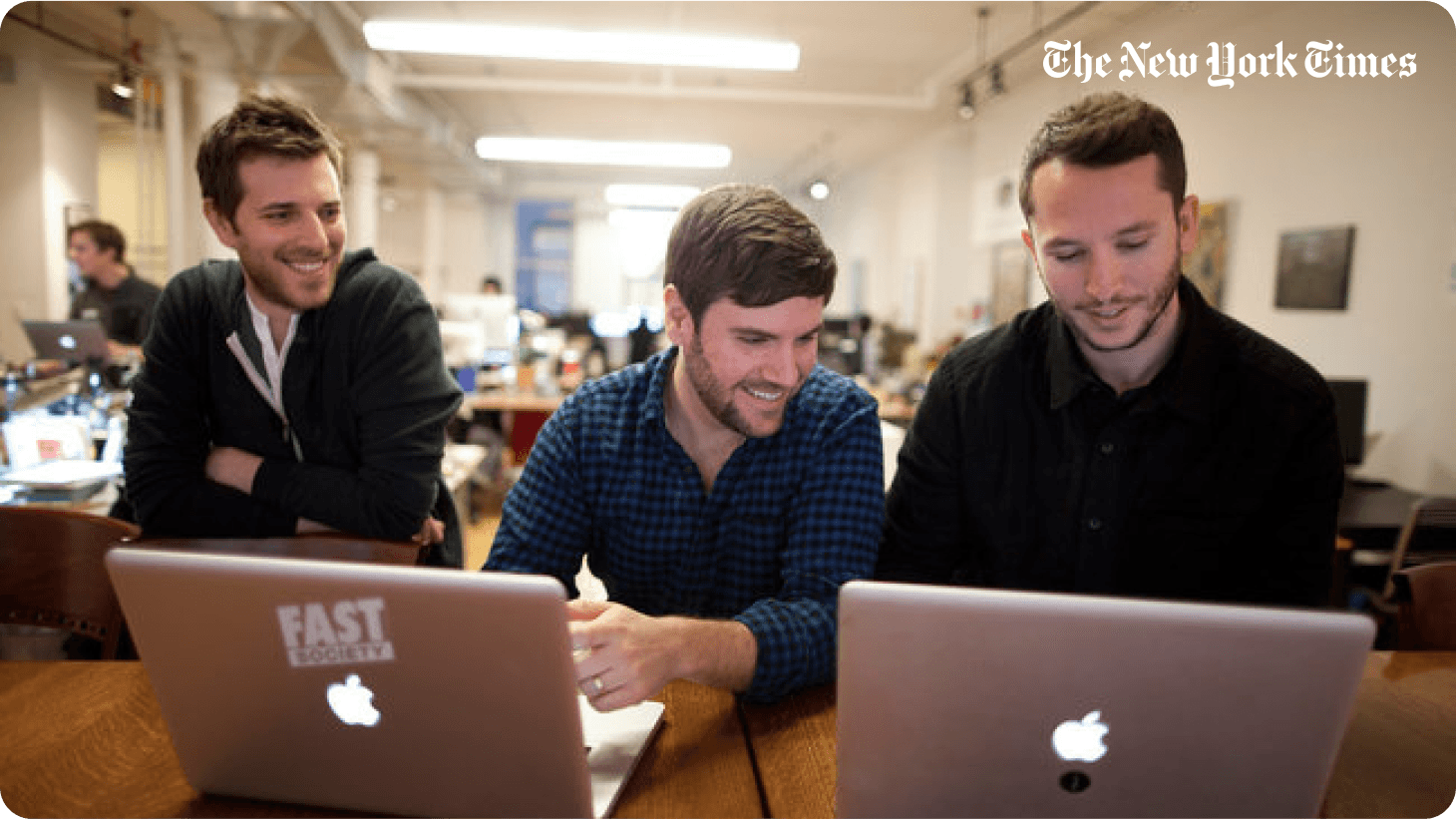 Matthew Rosenberg and his Fast Society co-founders working on laptops, photographed for The New York Times